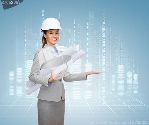 Image of smiling architect in white helmet with blueprints