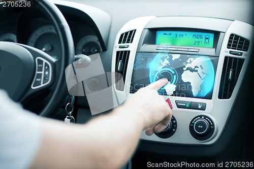Image of man using car control panel