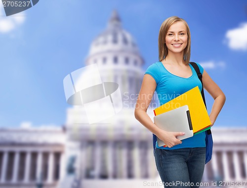 Image of smiling student with bag, folders and tablet pc