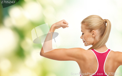 Image of sporty woman showing her biceps