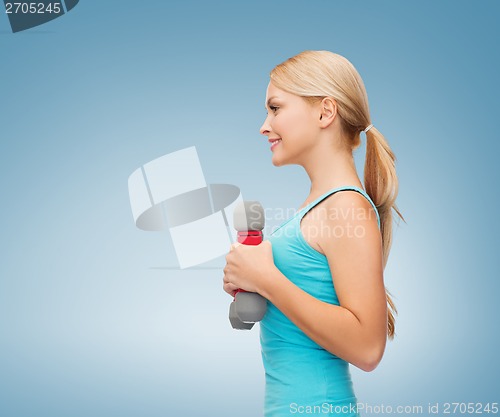 Image of young sporty woman with light dumbbells