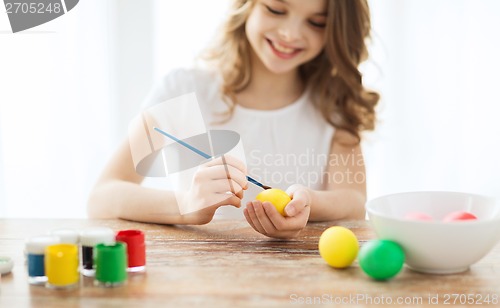 Image of close up of girl coloring eggs for easter