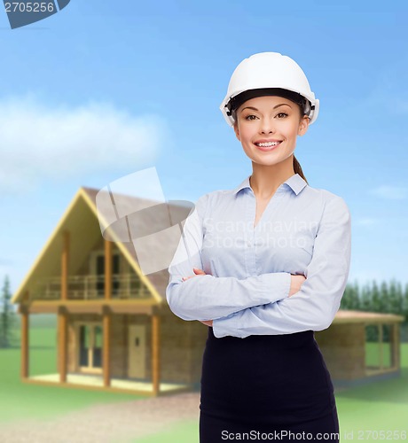 Image of friendly smiling businesswoman in white helmet