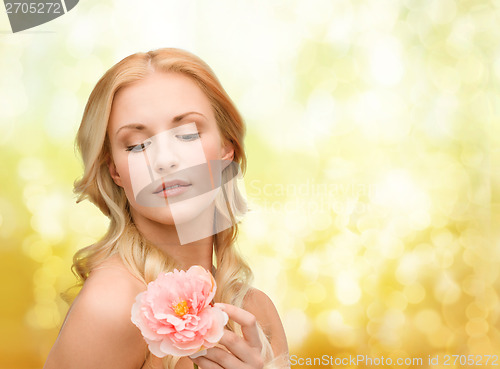 Image of lovely woman with peony flower