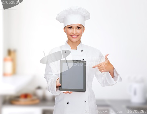 Image of smiling female chef with tablet pc blank screen