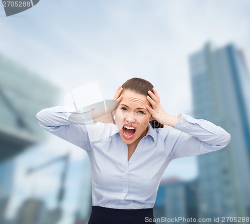 Image of angry screaming businesswoman outdoors
