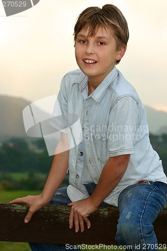 Image of Child sitting on fence