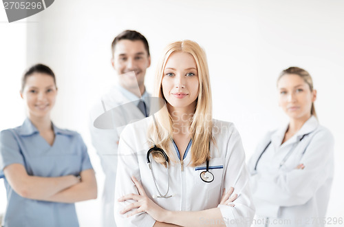 Image of female doctor in front of medical group