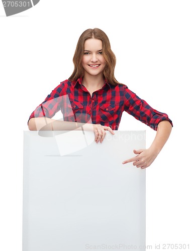 Image of smiling young teenage girl with white blank board