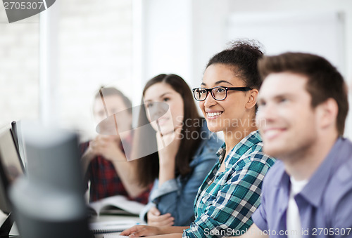 Image of students with computers studying at school