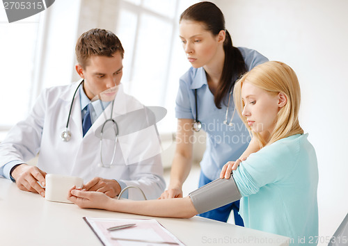 Image of male doctor, female nurse and patient in hospital