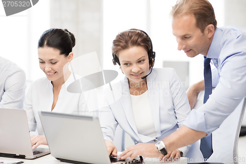 Image of group of people working in call center