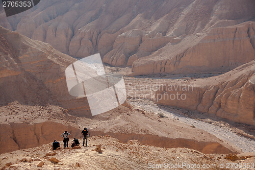 Image of Tourists hiking in dead sea mountains