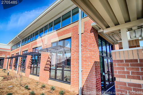 Image of brick building architecture with suncreen shades on windows