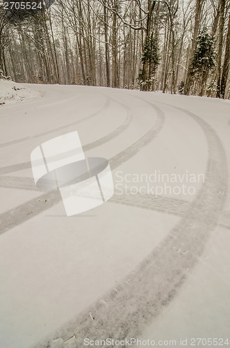 Image of snow covered road and trees after winter storm