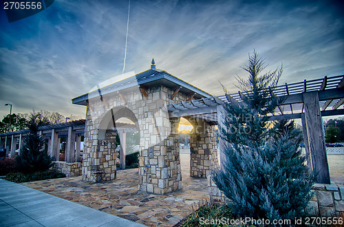 Image of cultured stone terrace trellis details near park in a city 