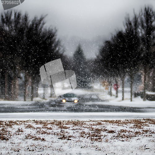 Image of snow covered road and trees after winter storm