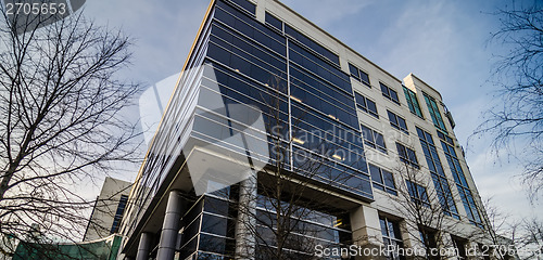 Image of modern architecture with glass and columns and metal panels