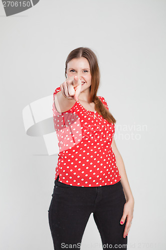 Image of Attractive woman pointing