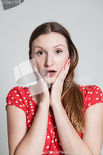 Image of Surprised looking attractive woman