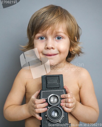 Image of boy with an old camera