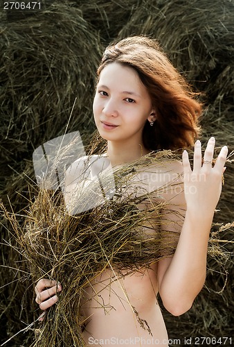 Image of beautiful sexy young nude woman on hay