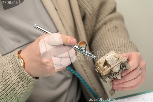 Image of Man painting truck model