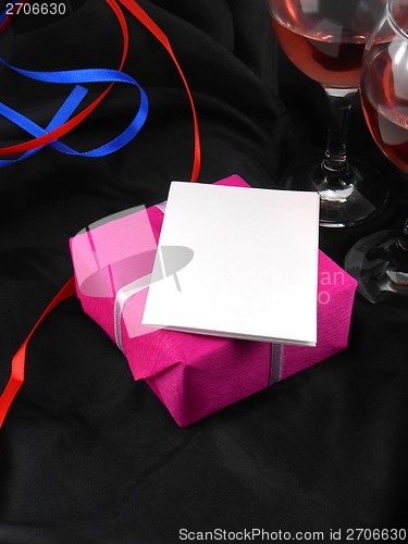 Image of Two champagne glasses and red gift box