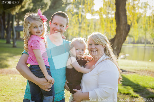 Image of Young Attractive Family Portrait in the Park