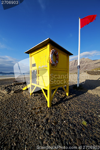 Image of lifeguard chair red flag  coastline and summer 