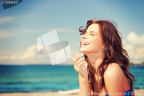 Image of laughing woman on the beach