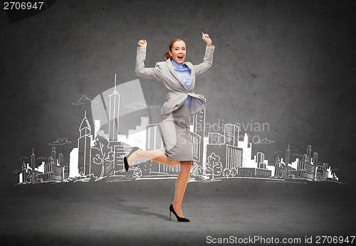 Image of happy woman jumping with hands up