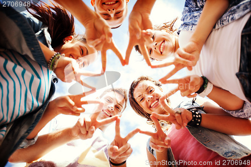 Image of group of teenagers showing finger five