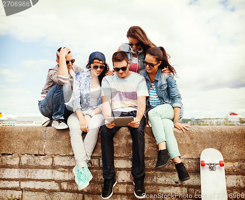 Image of group of teenagers looking at tablet pc