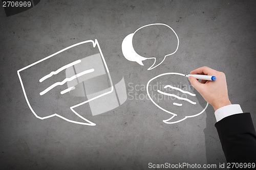 Image of close up of businessman drawing message bubbles