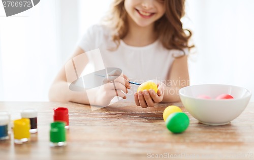 Image of close up of girl coloring eggs for easter
