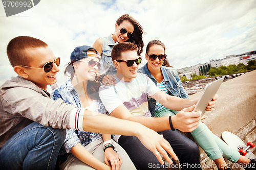 Image of group of teenagers looking at tablet pc