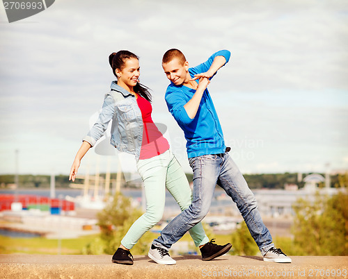 Image of couple of teenagers dancing outside