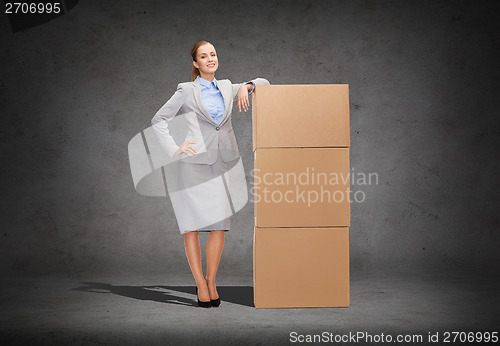 Image of smiling businesswoman with cardboard boxes