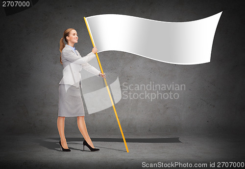Image of smiling woman holding flagpole with white flag