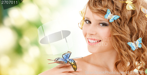 Image of happy teenage girl with butterflies in hair