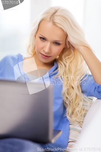 Image of woman with laptop computer at home