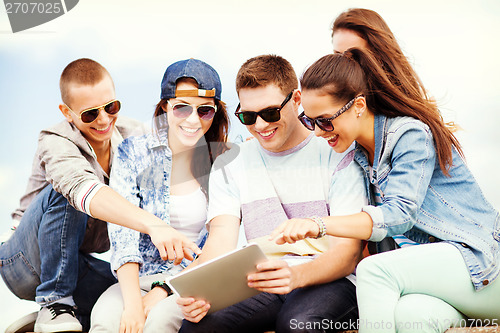 Image of group of teenagers looking at tablet pc