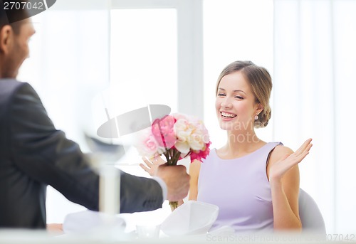 Image of amazed woman recieving bouquet of flowers