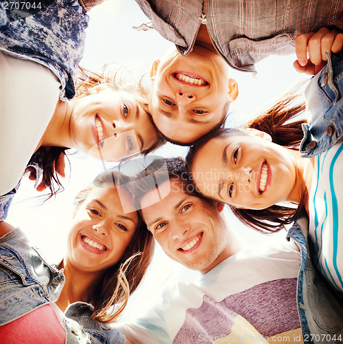 Image of group of teenagers looking down