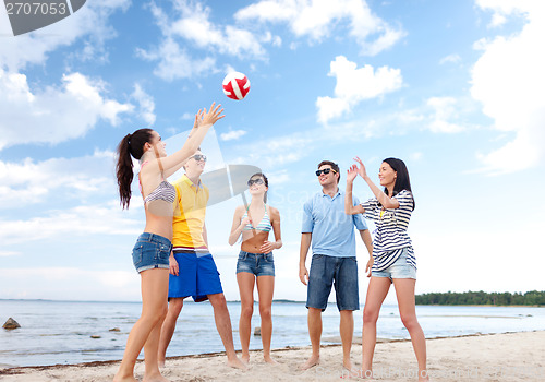 Image of group of friends having fun on the beach
