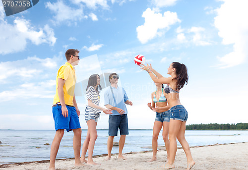 Image of group of friends having fun on the beach