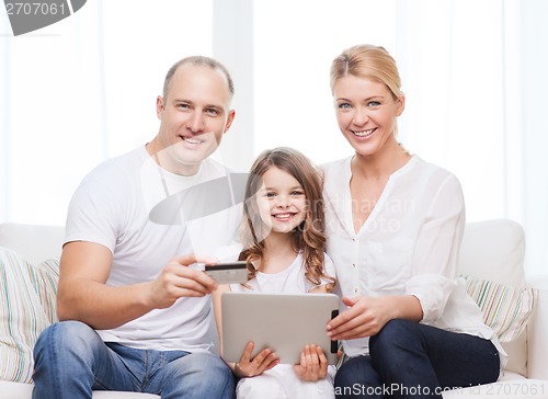 Image of parents and girl with tablet pc and credit card