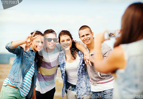 Image of teenagers taking photo outside