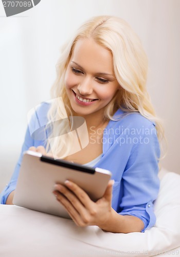 Image of smiling woman with tablet pc computer at home